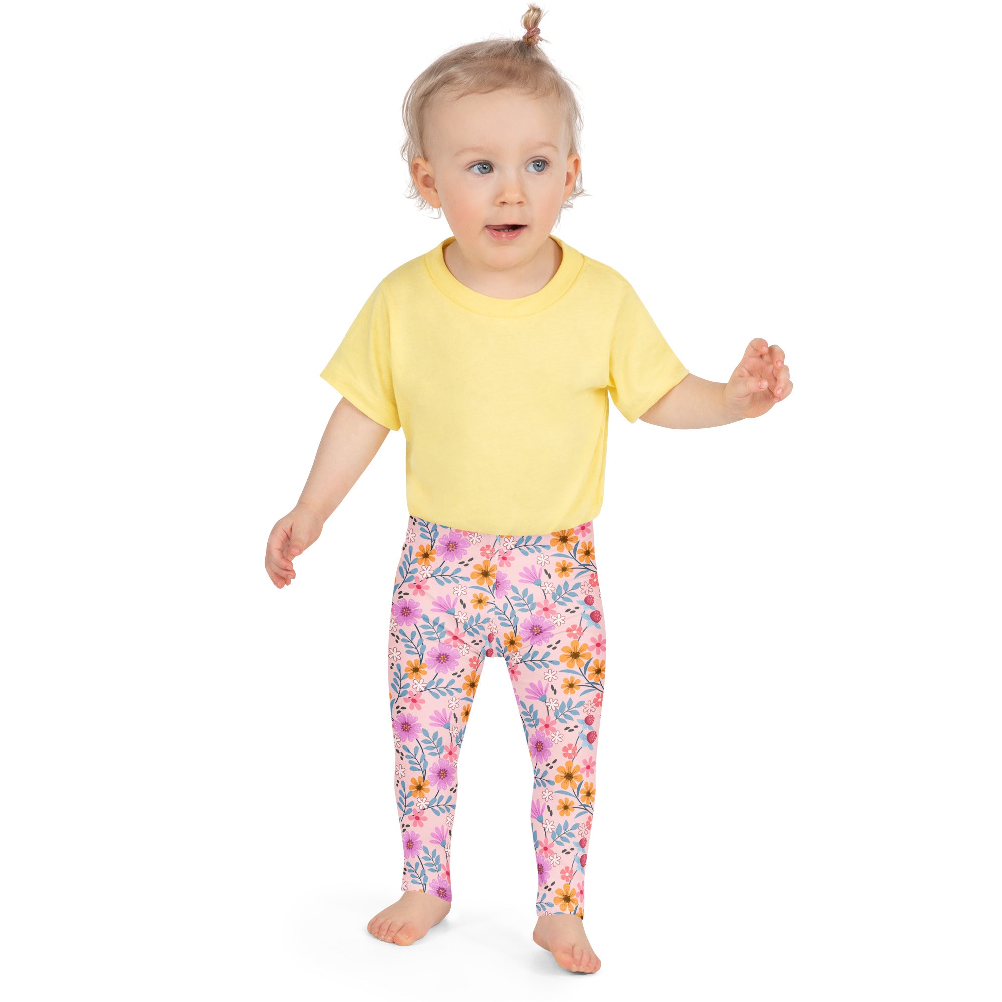 Girls pink floral buttery soft leggings featuring yellow and purple flowers on a light pink background