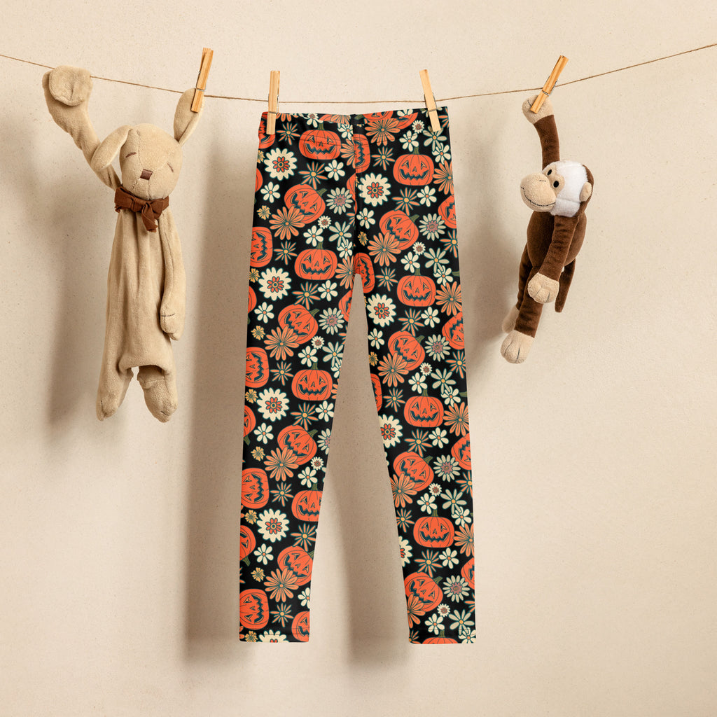 Kids vintage Halloween pumpkin floral buttery soft black leggings with vibrant orange jack-o-lanterns and white flowers