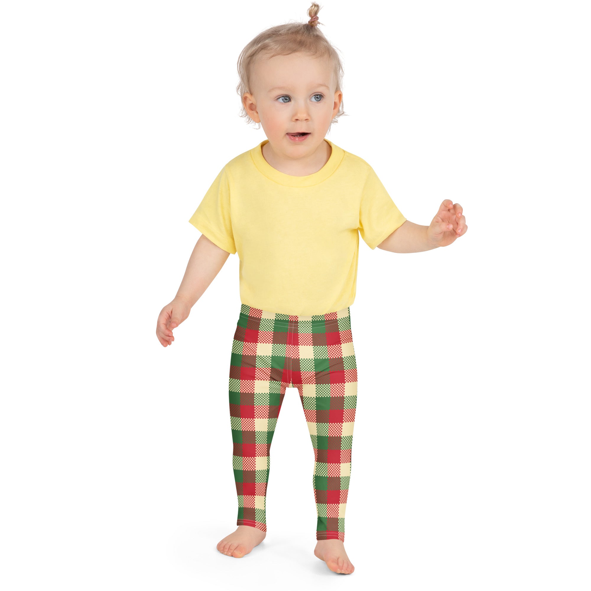 Child wearing kids christmas plaid buttery soft leggings in festive red green and cream with a yellow t-shirt