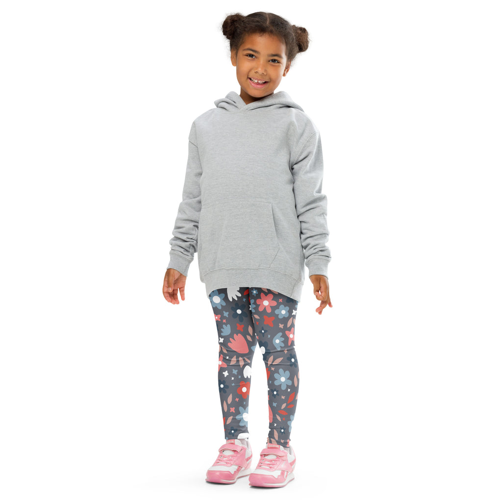 A child wearing gray floral pattern buttery soft leggings with a light gray hooded sweatshirt and front pocket