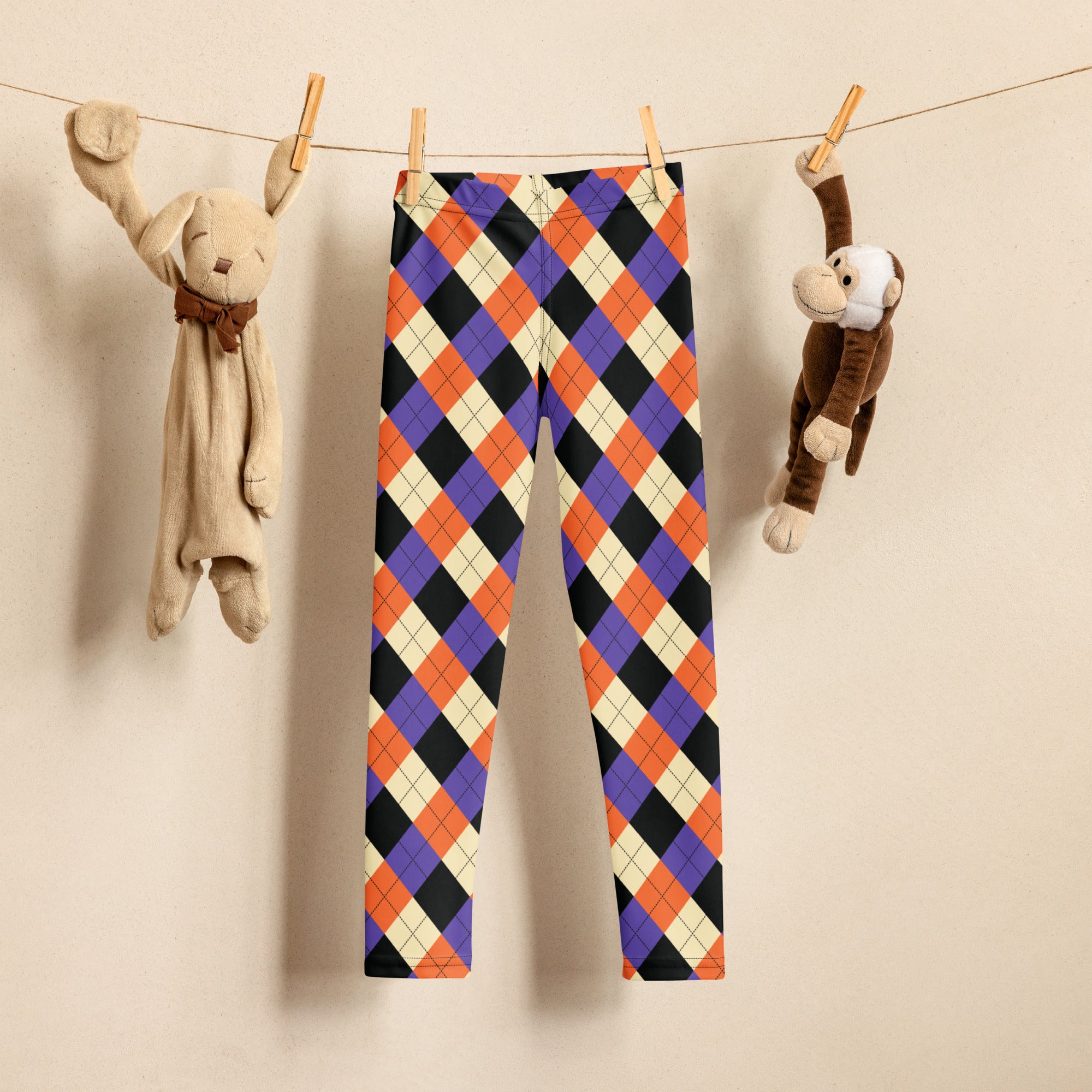 Kids halloween argyle buttery soft leggings in vibrant orange purple black and cream with a colorful pattern