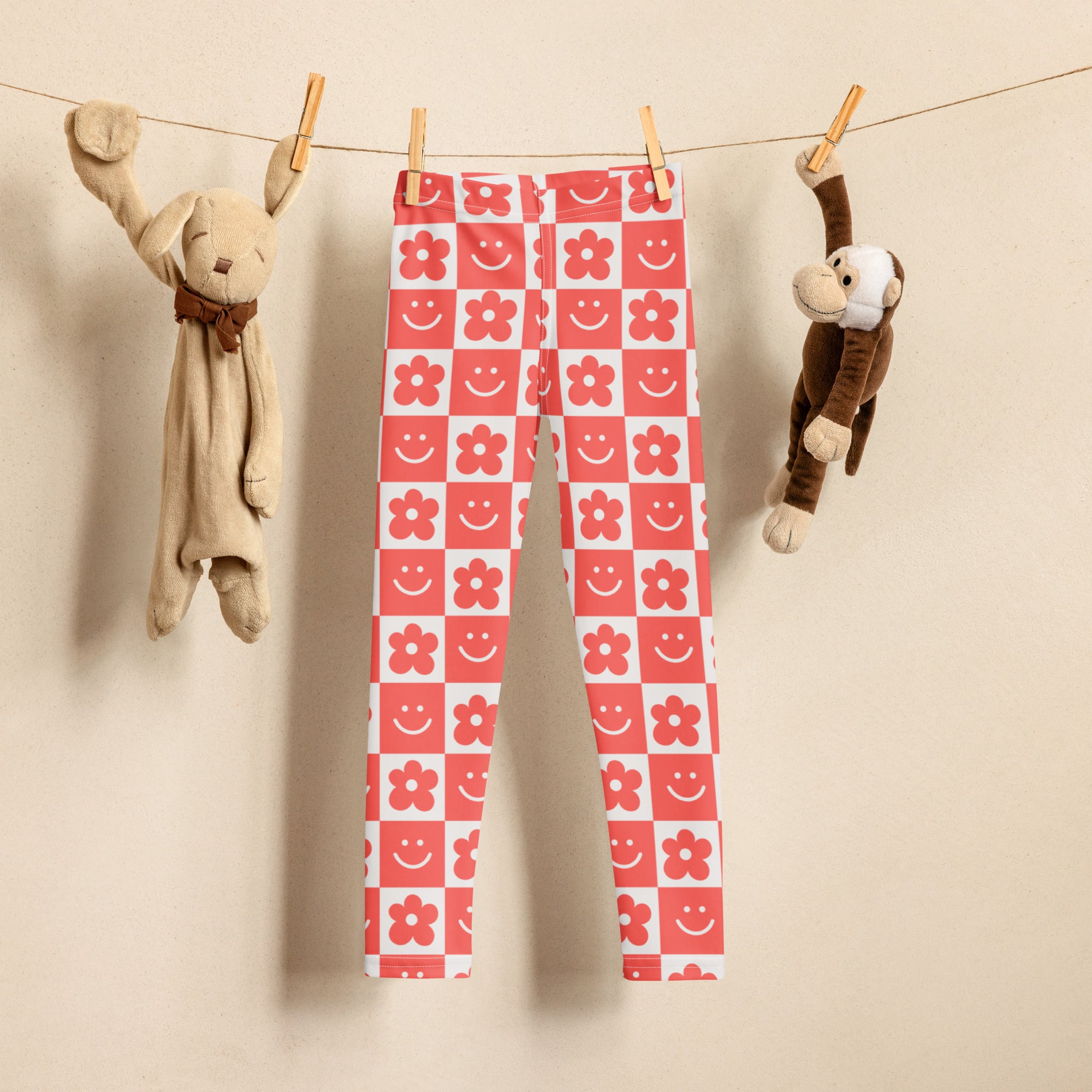 Girls red and white checkered buttery soft leggings with playful pink flowers and smile faces pattern
