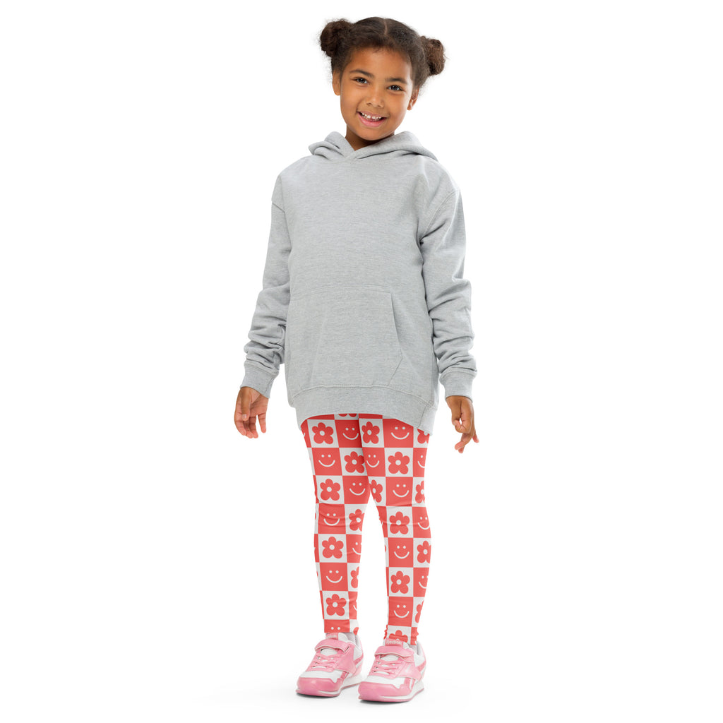Gray hooded sweatshirt with front pocket and long sleeves paired with girls red checkerboard flower smile face leggings