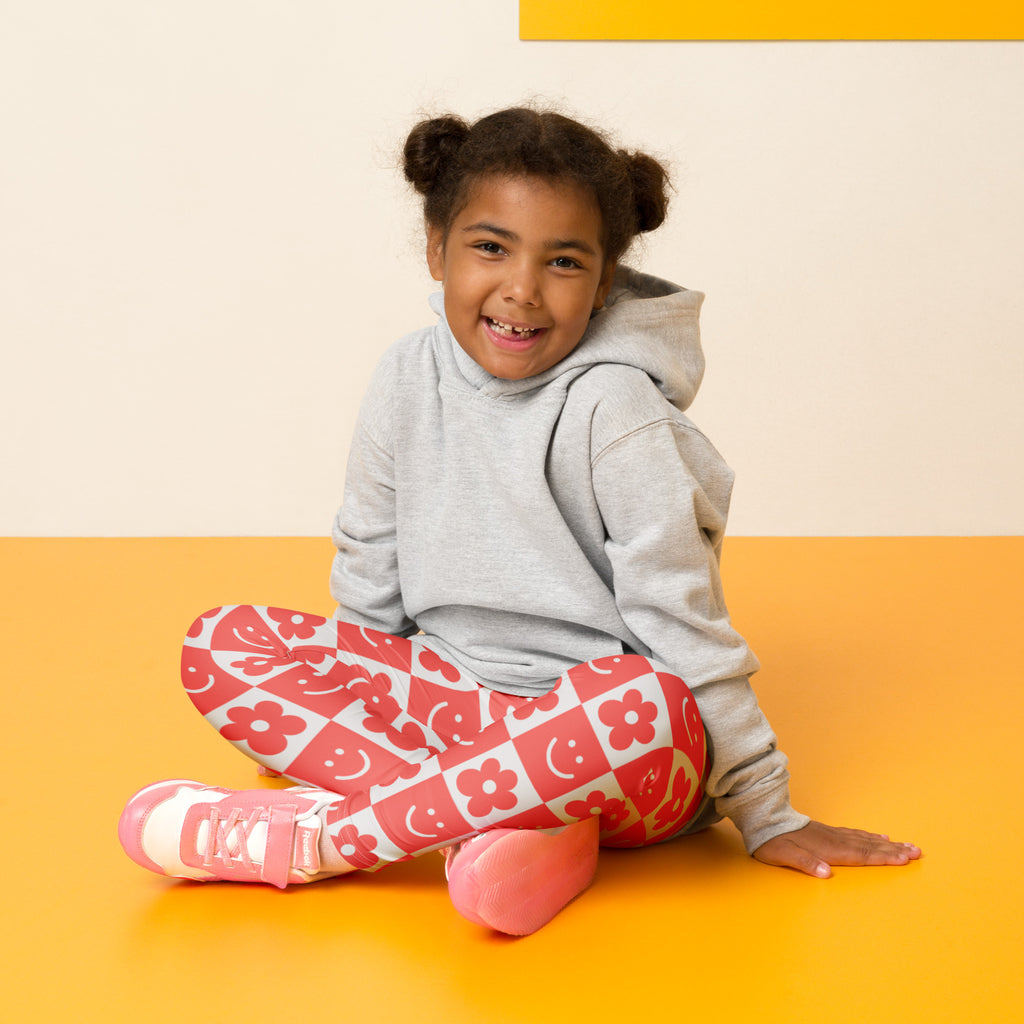 Girls red checkerboard flower and smile face buttery soft leggings with pink and white floral pattern on red checkered background