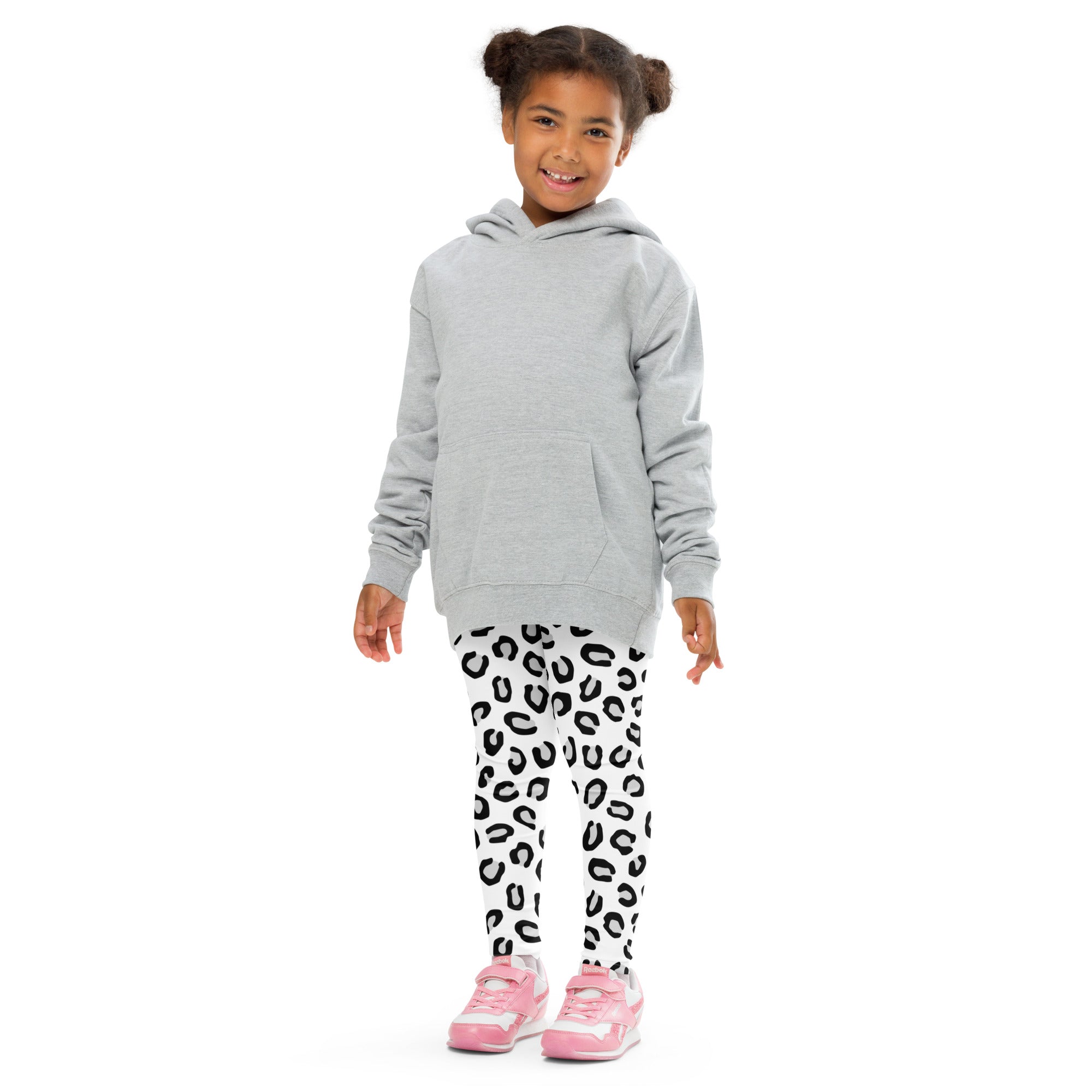 Gray hooded sweatshirt with long sleeves and front pocket worn over girls black and white leopard print buttery soft leggings