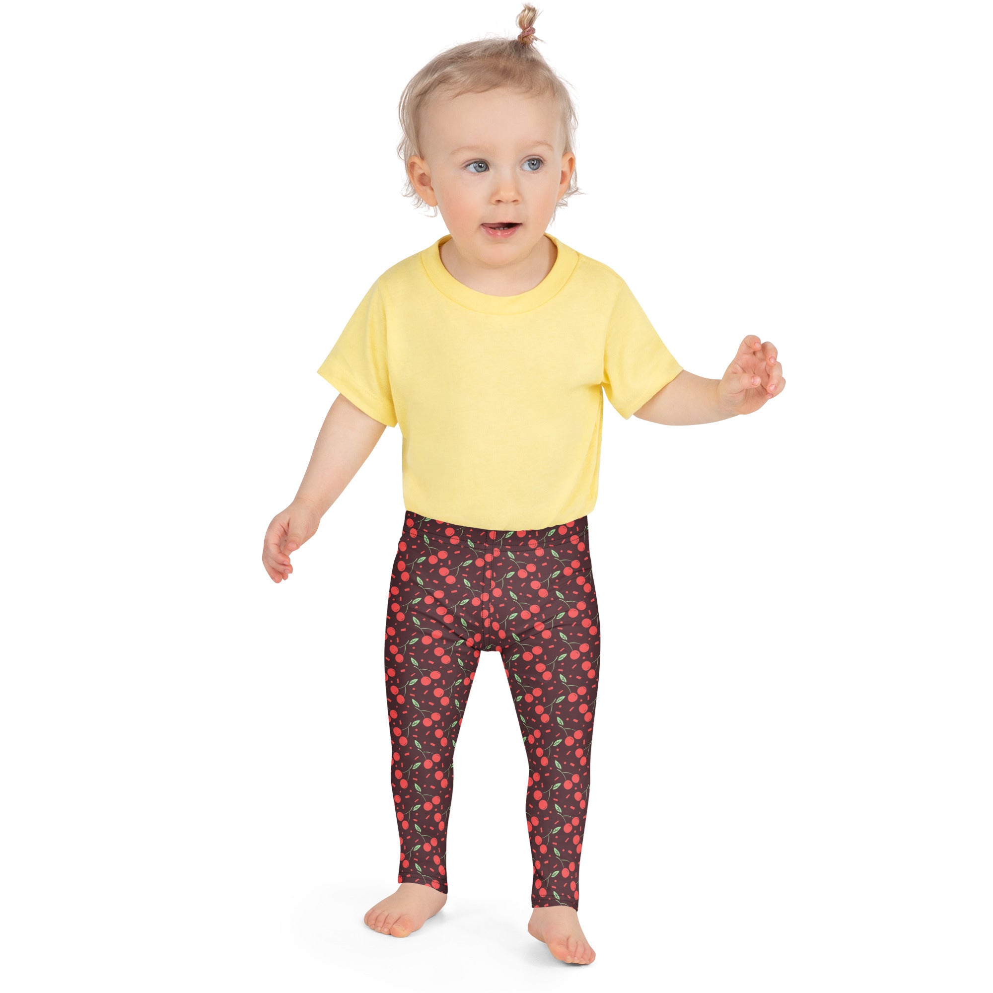 Yellow short-sleeved t-shirt paired with dark red buttery soft leggings featuring a repeating cherry pattern