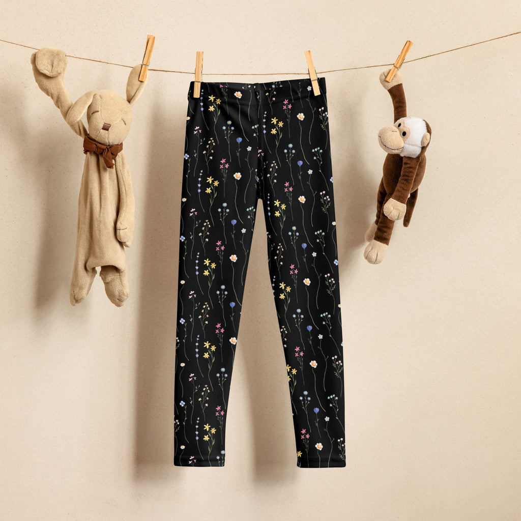 Girls black wildflower buttery soft leggings with delicate pastel yellow pink and blue floral pattern