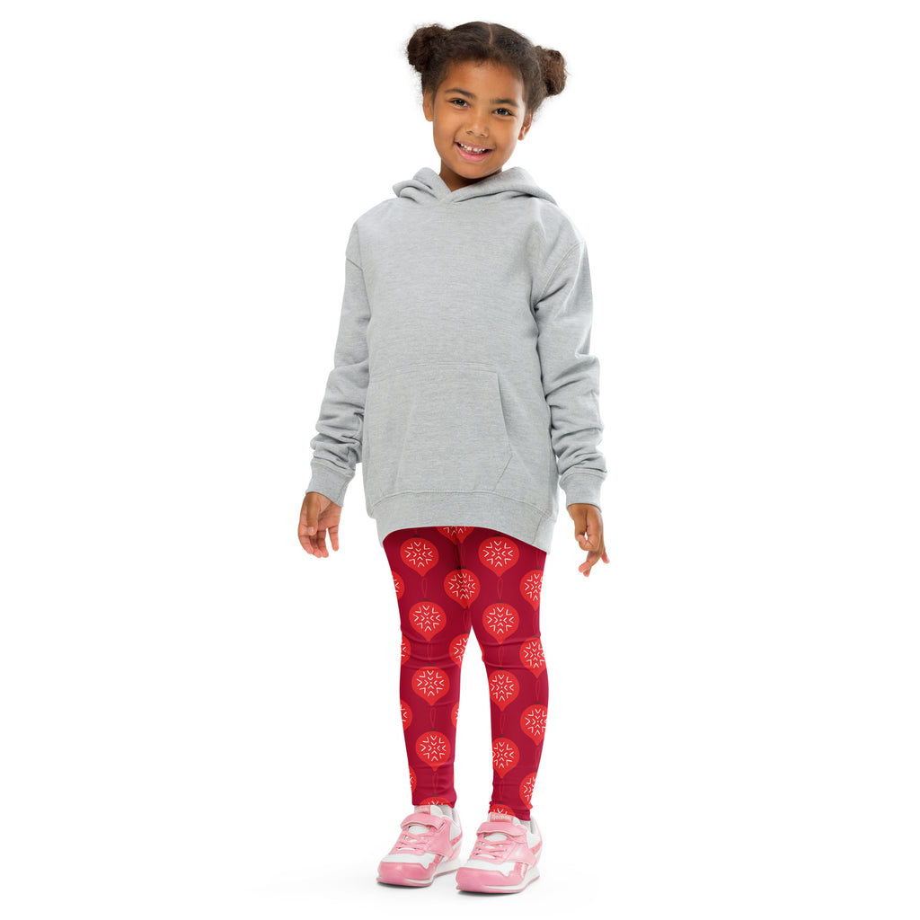 Gray hooded sweatshirt with long sleeves and front pocket worn over girls buttery soft red Christmas ornament leggings