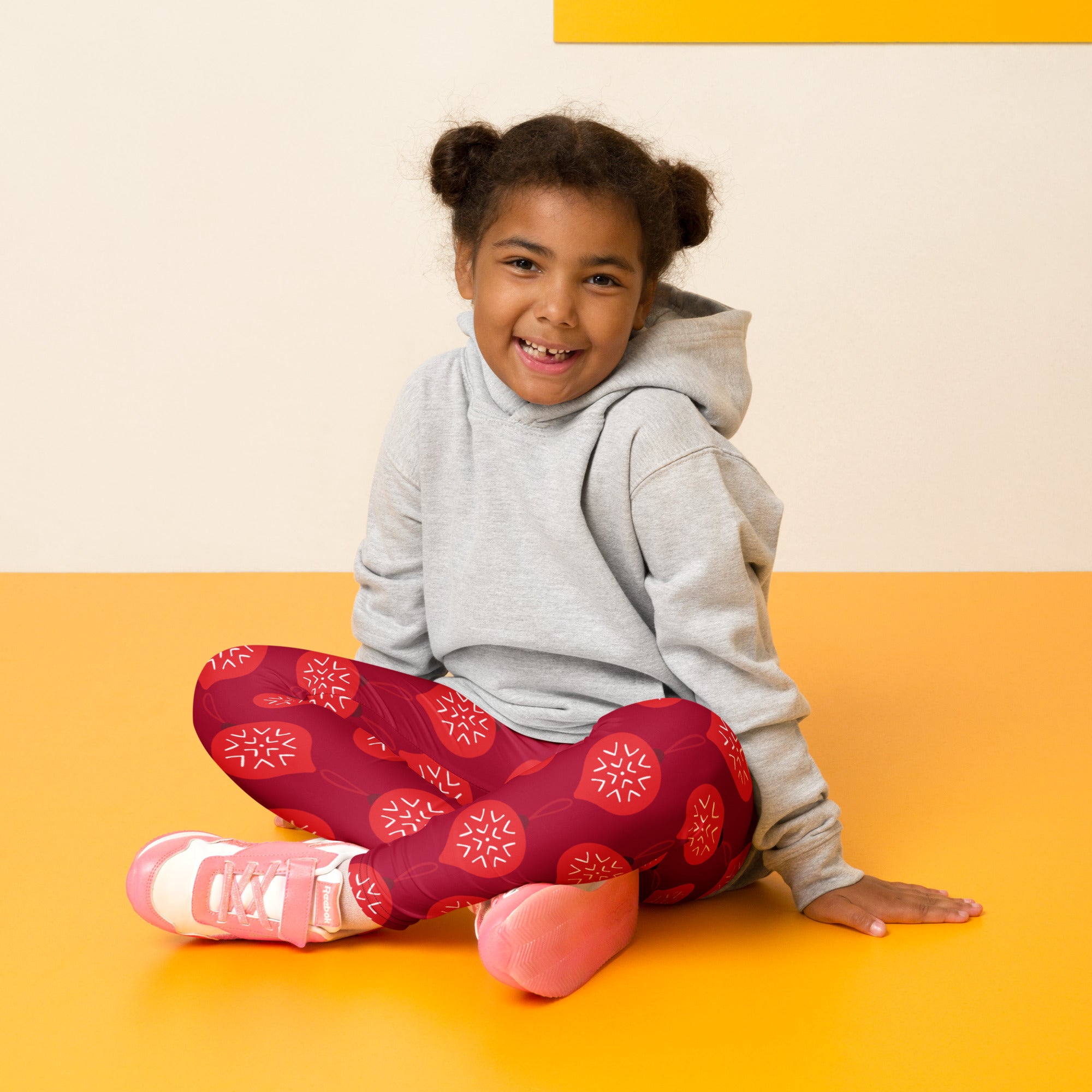 A child wearing girls christmas ornament buttery soft red leggings with white snowflake pattern