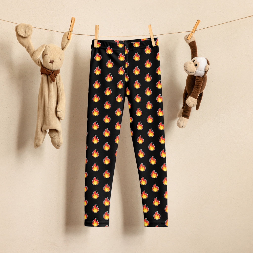 Black kids leggings with a buttery soft fabric featuring a repeating pattern of vibrant orange and yellow flames