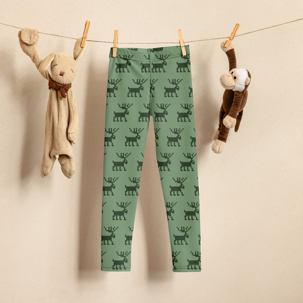 Kids green buttery soft leggings with a dark green pixelated reindeer pattern perfect for Christmas wear