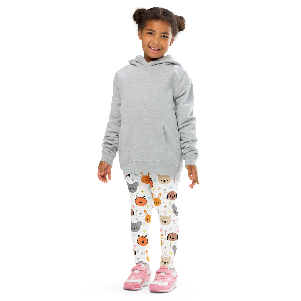Gray long sleeve hooded sweatshirt worn over white buttery soft kids leggings with colorful cartoon animal faces pattern