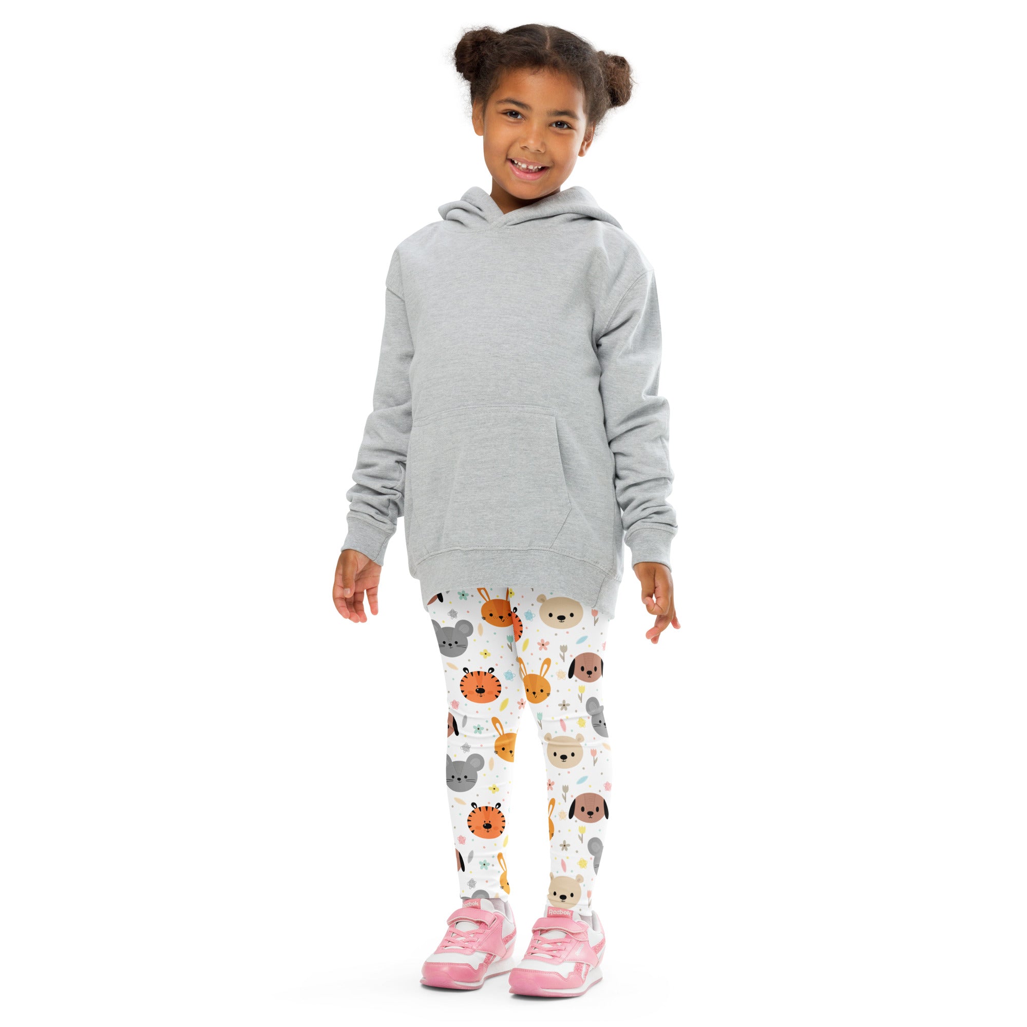 Gray long sleeve hooded sweatshirt worn over white buttery soft kids leggings with colorful cartoon animal faces pattern