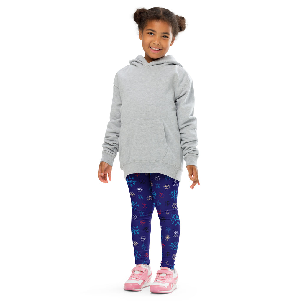 A child wearing kids snowflake pattern buttery soft dark blue leggings with colorful snowflakes and a light gray hooded sweatshirt