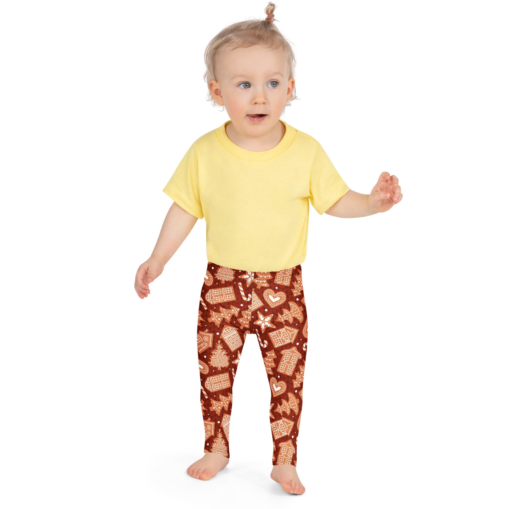A child wearing kids red gingerbread cookie Christmas buttery soft leggings with brown base and white icing designs