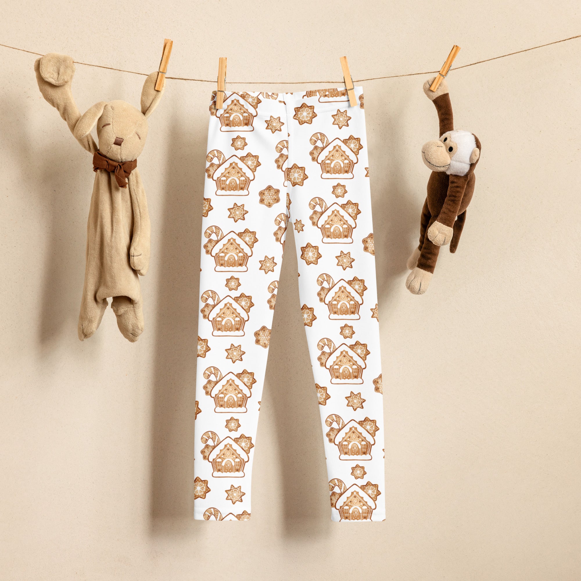 White buttery soft kids leggings with festive brown gingerbread house and star pattern for christmas wear