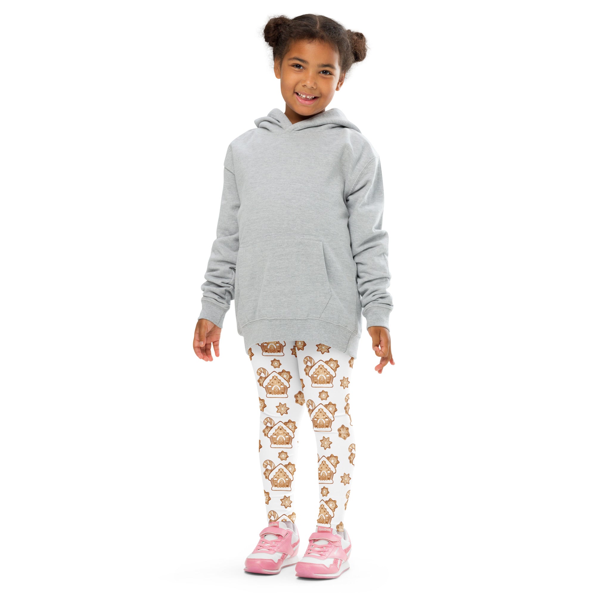 Gray hooded sweatshirt with front pocket worn over white buttery soft kids leggings with gingerbread house patterns