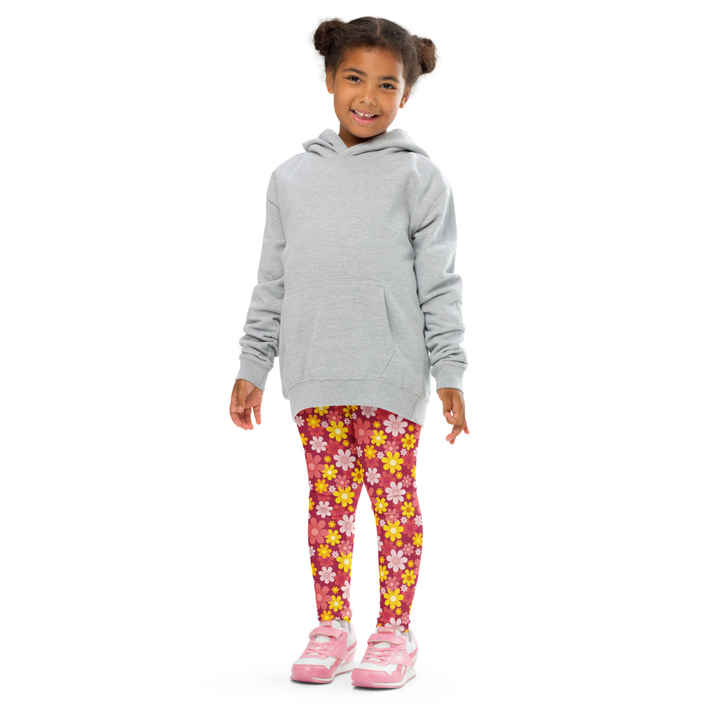 A child wearing girls red floral buttery soft vibrant pink leggings with colorful patterns and matching pink sneakers