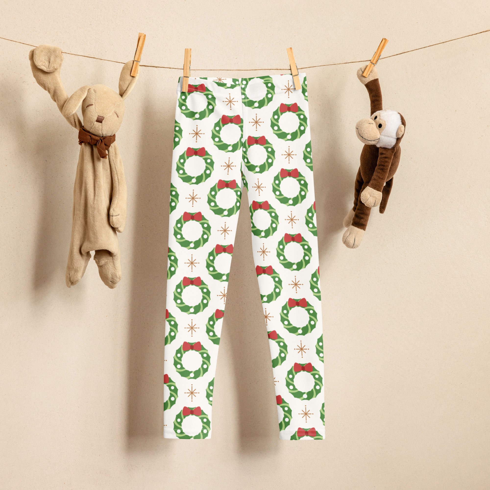 Kids holiday wreath buttery soft white leggings with green wreaths red bows and gold starburst accents pattern