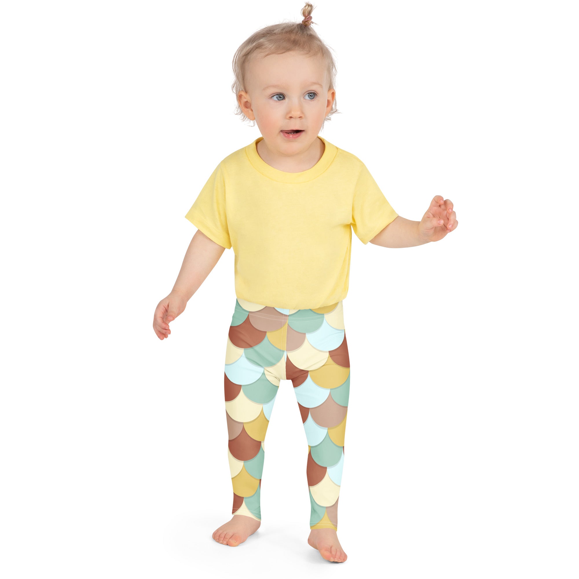Yellow short-sleeved t-shirt paired with girls green and brown mermaid buttery soft leggings with colorful scale pattern