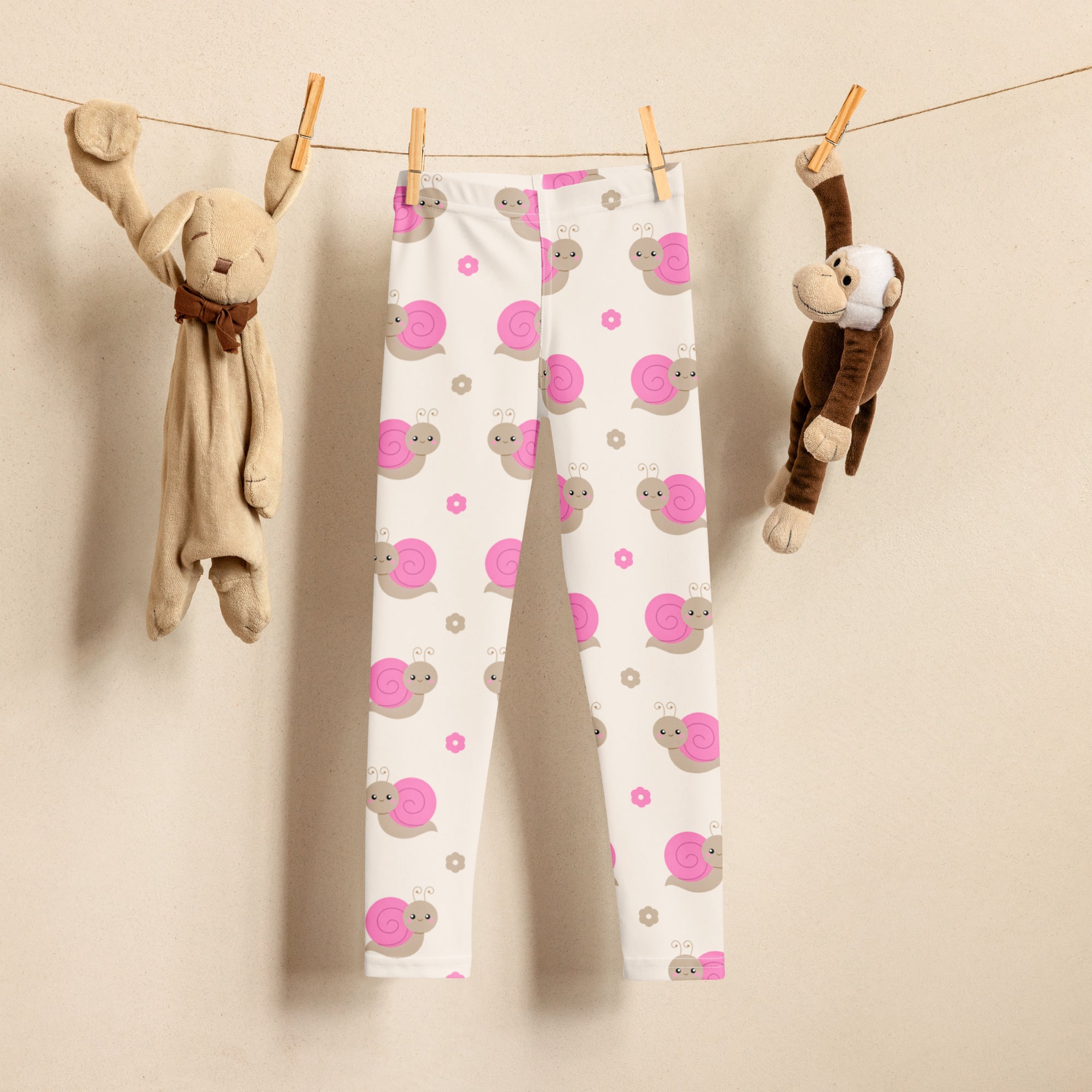 Girls pink snail buttery soft white leggings with playful pink and gray snail pattern and small flower accents