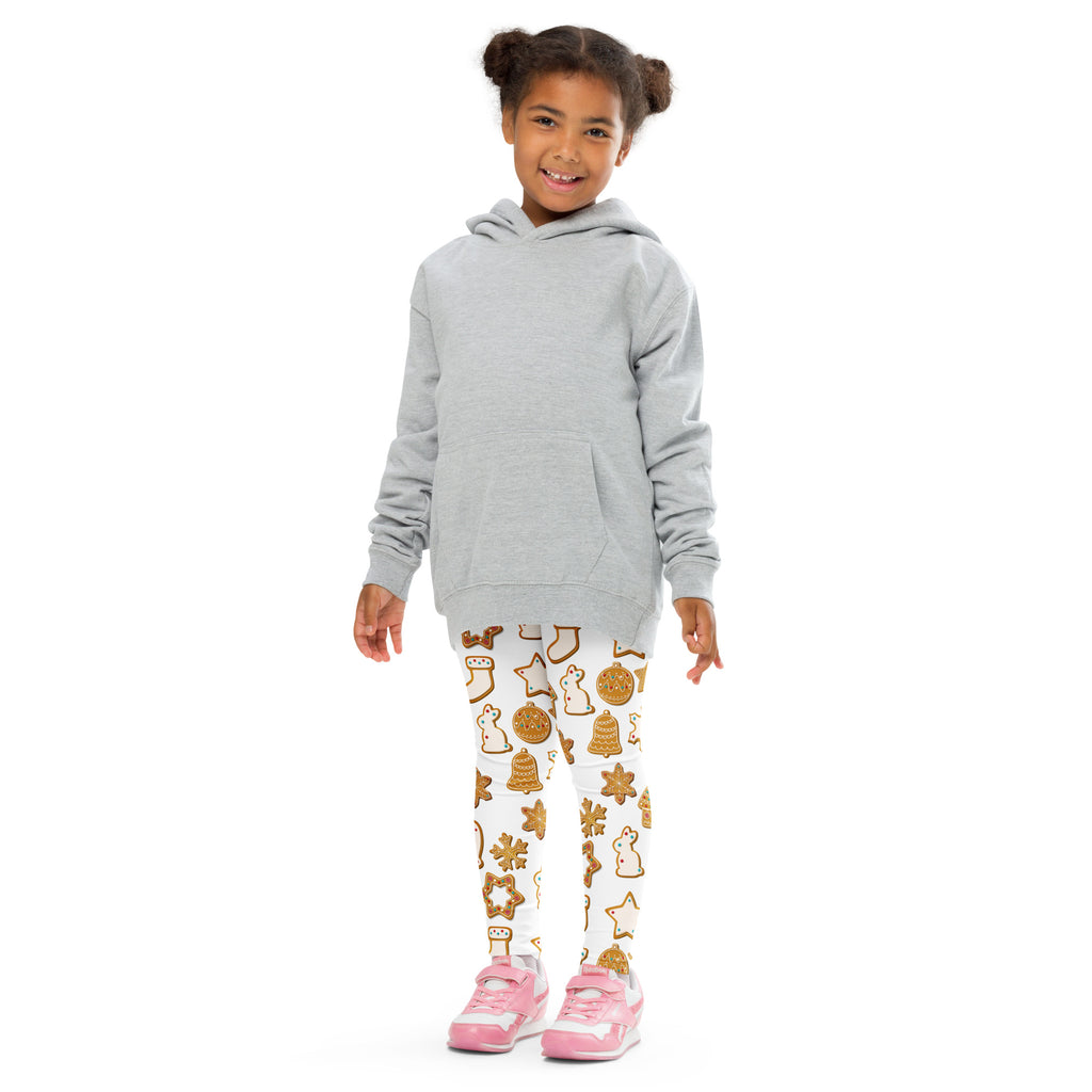 Gray hooded sweatshirt with long sleeves and front pocket worn over kids buttery soft white leggings with gingerbread cookie print