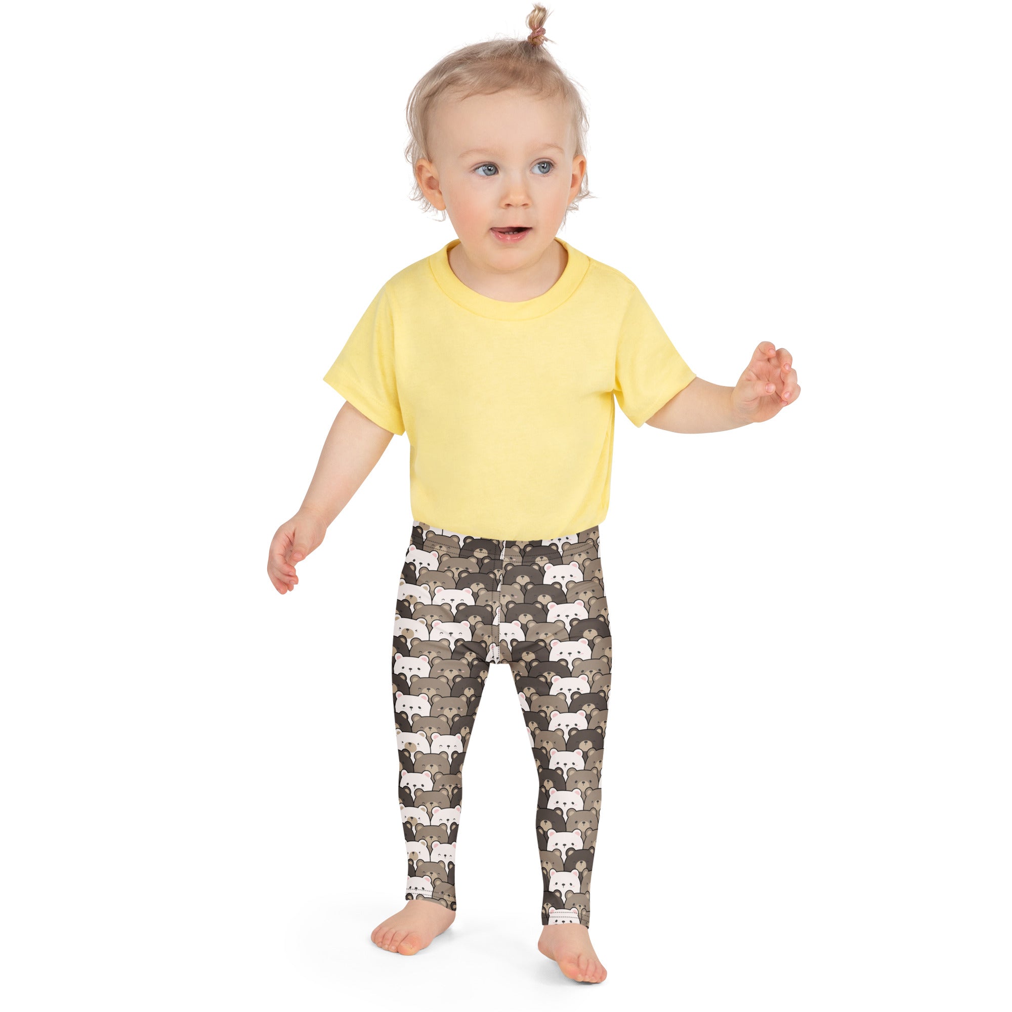 A child wearing kids brown bear print buttery soft leggings with white gray and brown cartoon foxes on dark background