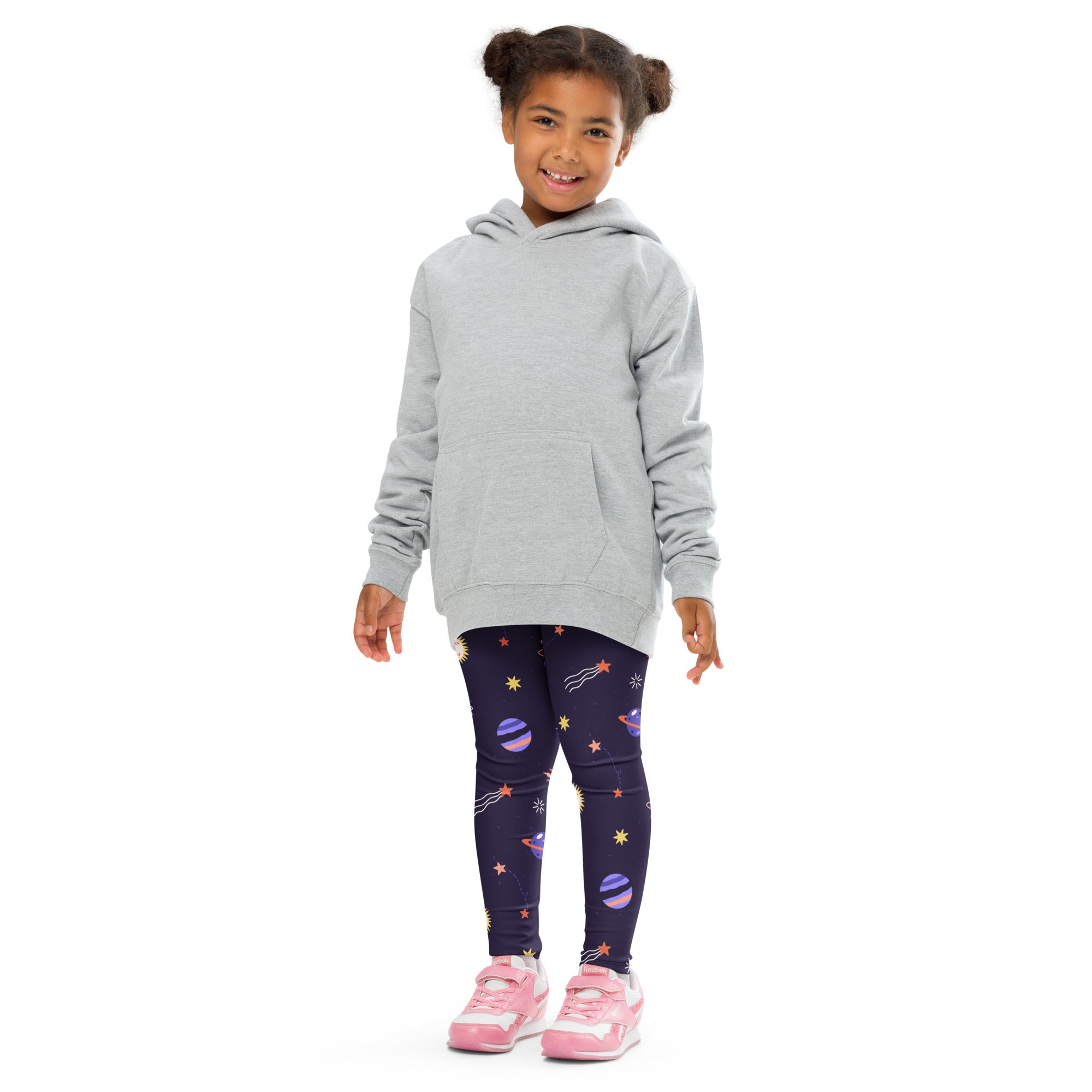 Girl wearing a gray hooded sweatshirt with front pocket and long sleeves paired with purple outer space leggings