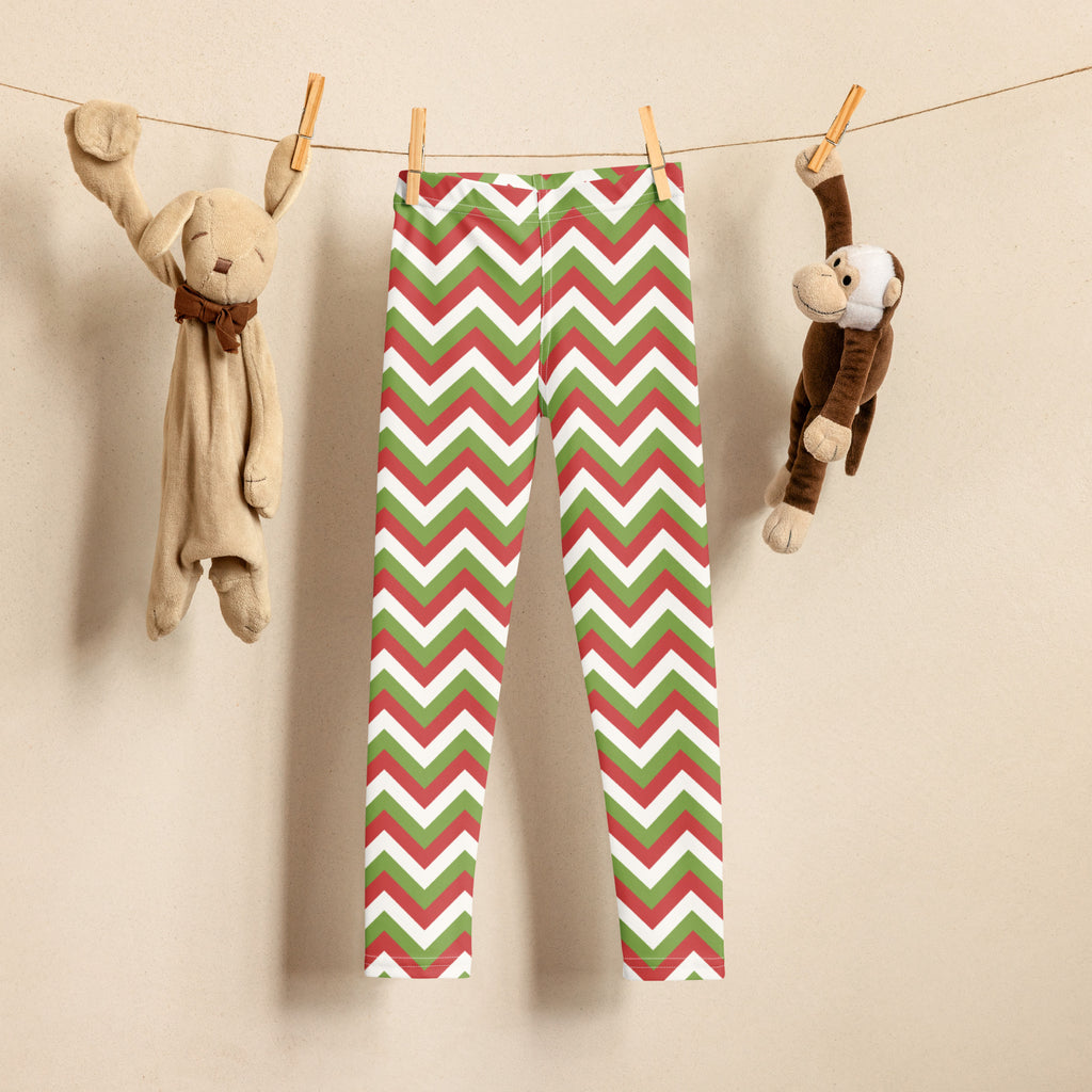 Kids christmas chevron buttery soft leggings in red green and white hanging on a clothesline
