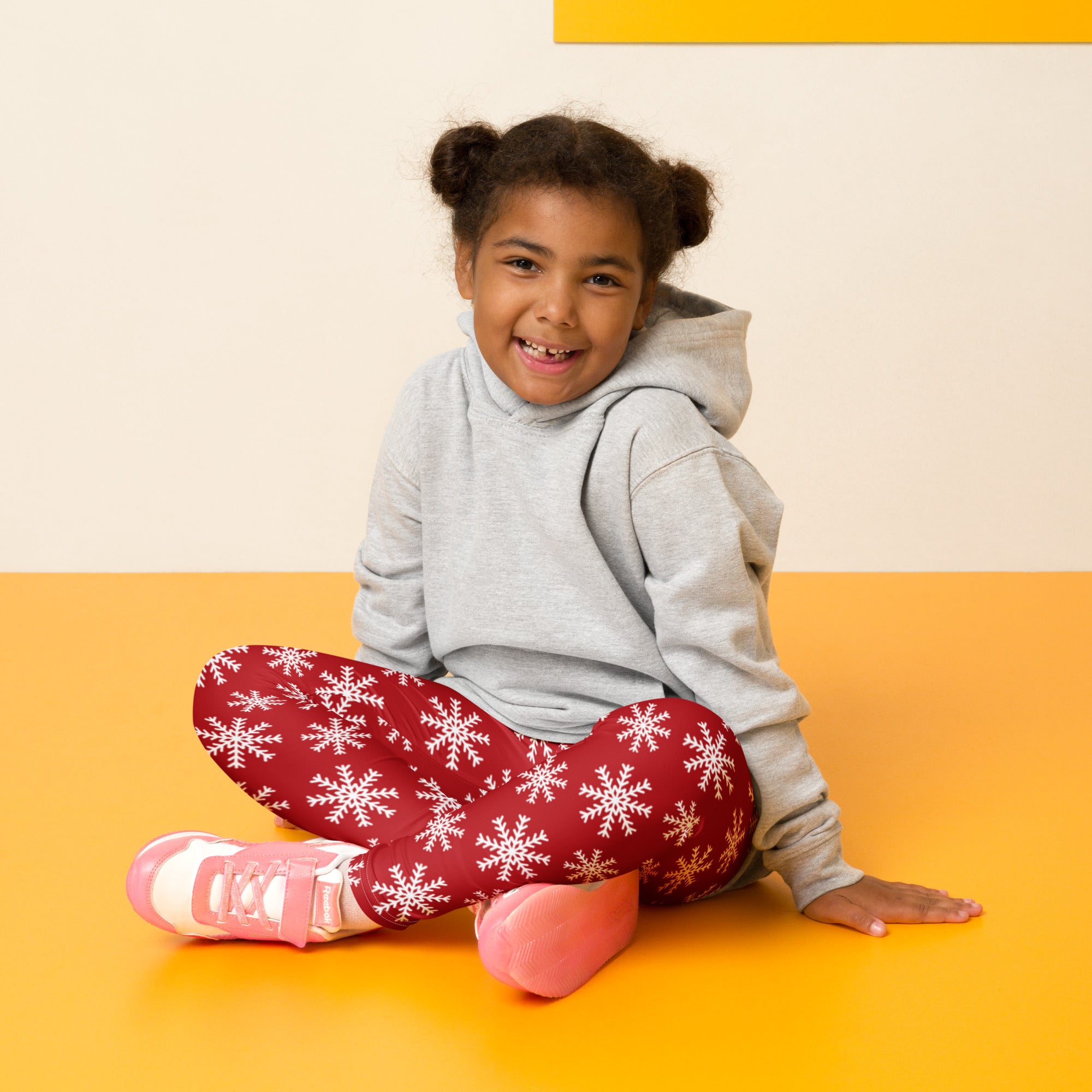 Kids red snowflake christmas buttery soft leggings featuring white snowflake patterns on red fabric