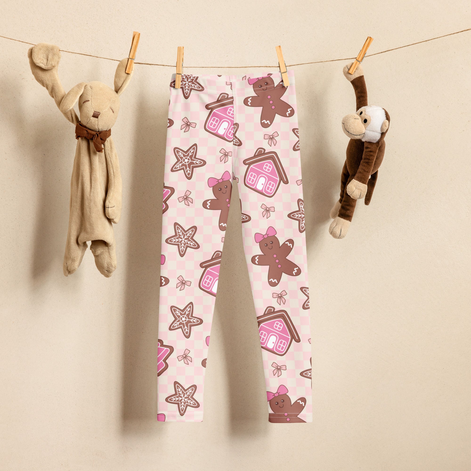 Girls pink buttery soft leggings with playful brown gingerbread men pink bows stars and tiny houses on light background