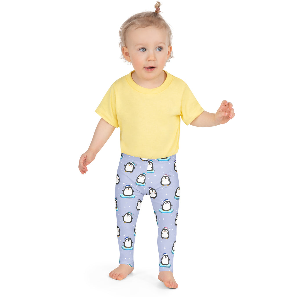 Light purple girls winter penguin Christmas buttery soft leggings with playful cartoon penguins wearing hats on ice