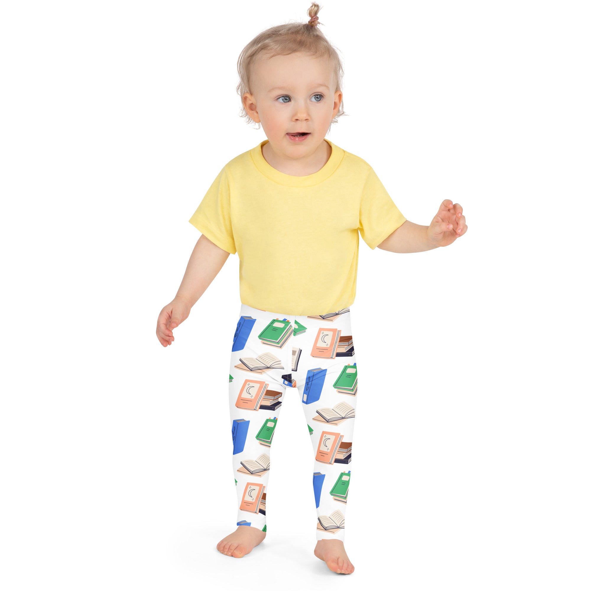 Toddler wearing a yellow short-sleeved t-shirt paired with kids book print buttery soft leggings for comfort