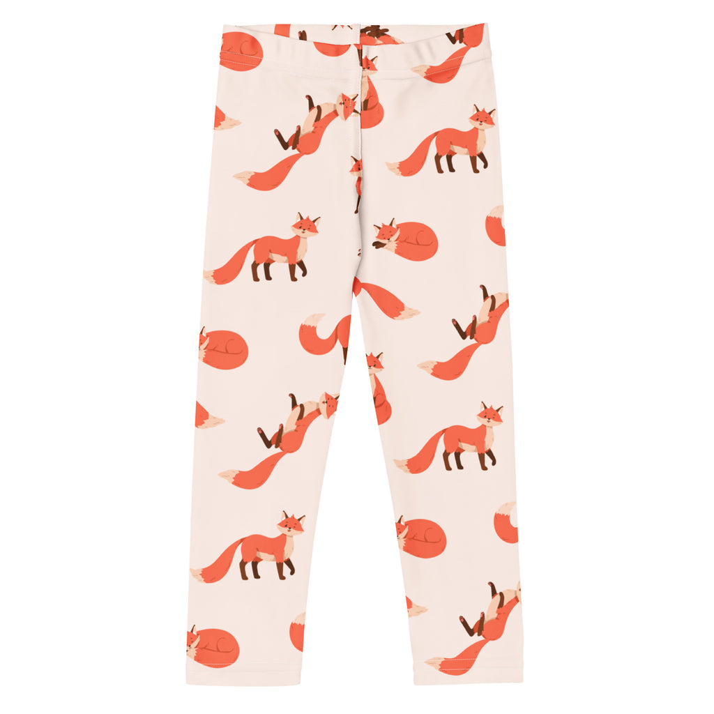 Cream-colored buttery soft kids leggings with playful orange fox print in various poses