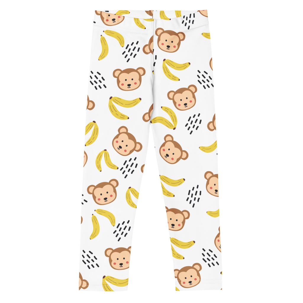 White kids leggings featuring a playful monkey and banana pattern with black dashed lines in buttery soft fabric