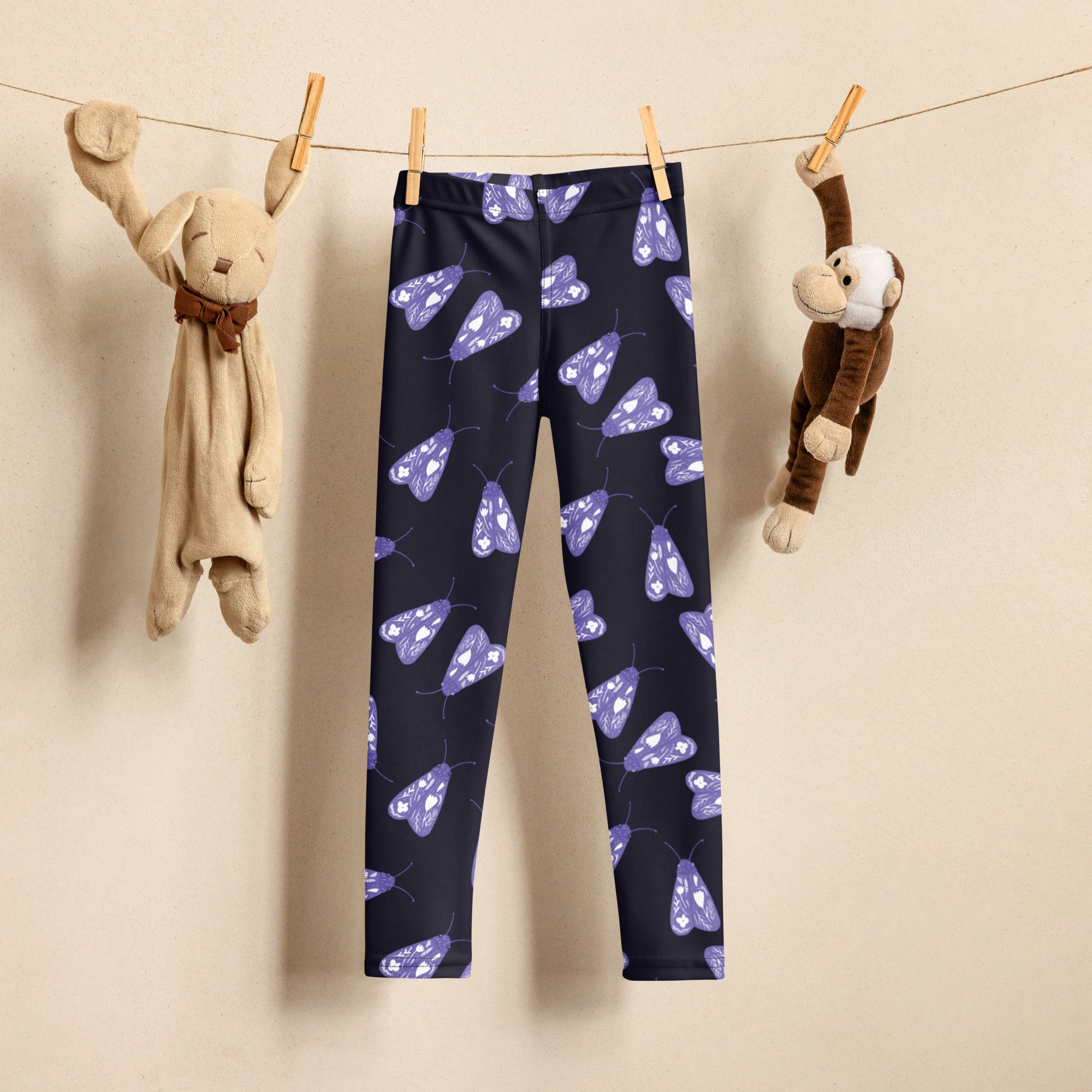 Girls purple moth buttery soft leggings in dark blue with playful purple moth designs and white accents