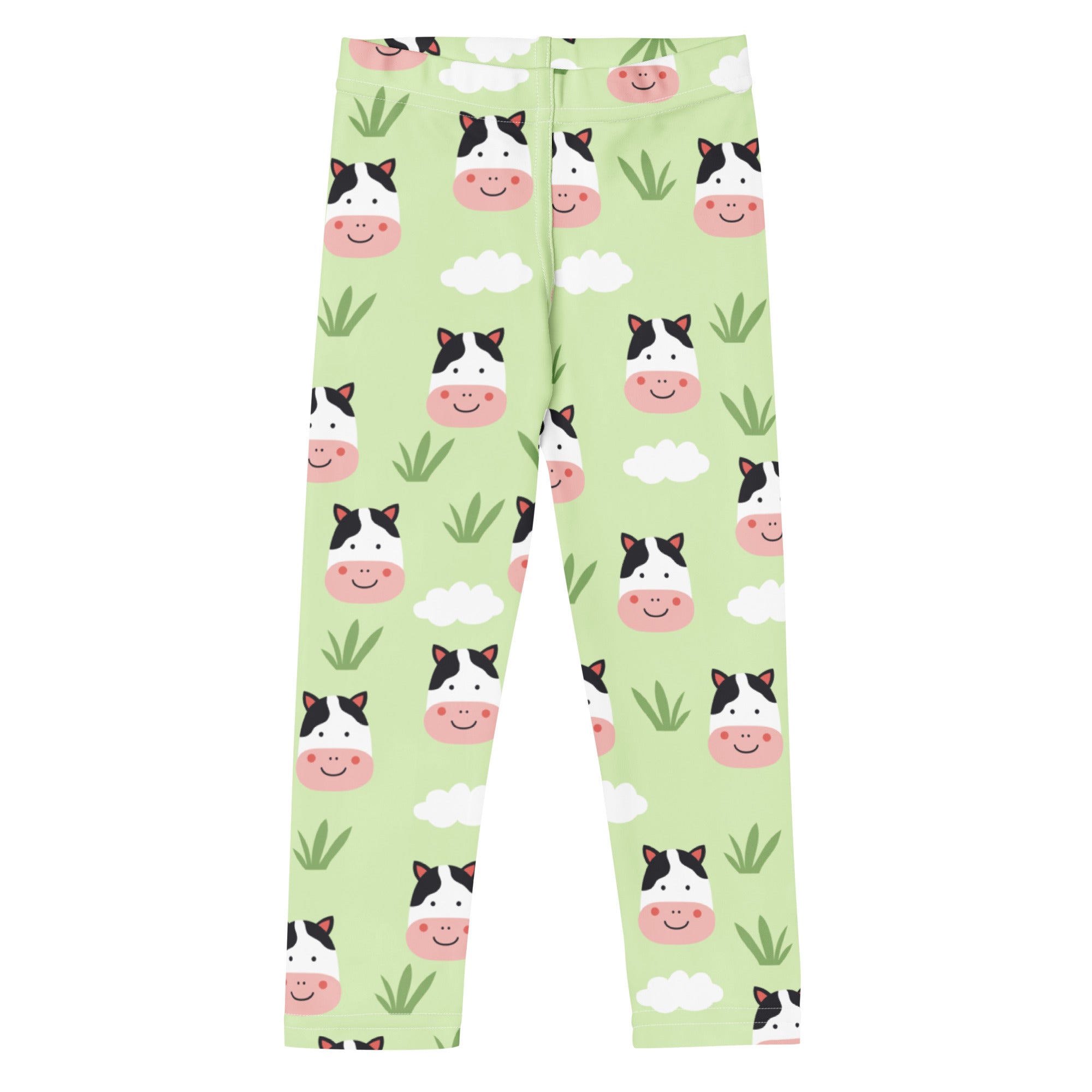 Kids cow print buttery soft leggings in light green with playful cartoon cow faces clouds and grass tufts pattern