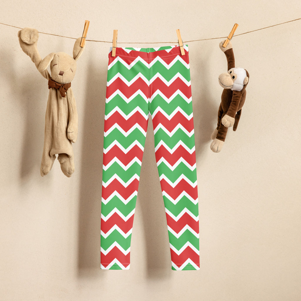Kids christmas chevron striped buttery soft leggings in red and green hanging on a clothesline