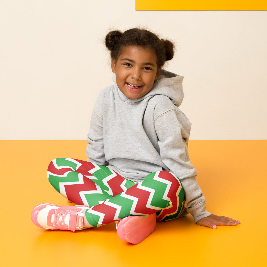 A child wearing kids christmas chevron striped buttery soft leggings in red and green with white trim