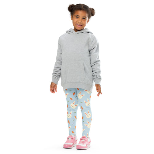 A child wearing girls Easter bunny carrot buttery soft pastel blue leggings with bunny and carrot prints and pink sneakers