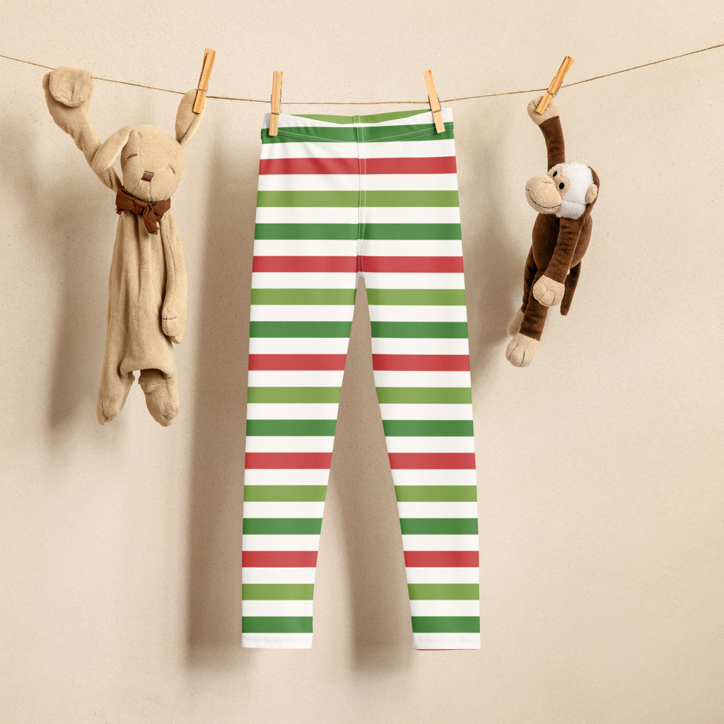 Kids red and green striped Christmas buttery soft leggings hanging on a clothesline showing front side
