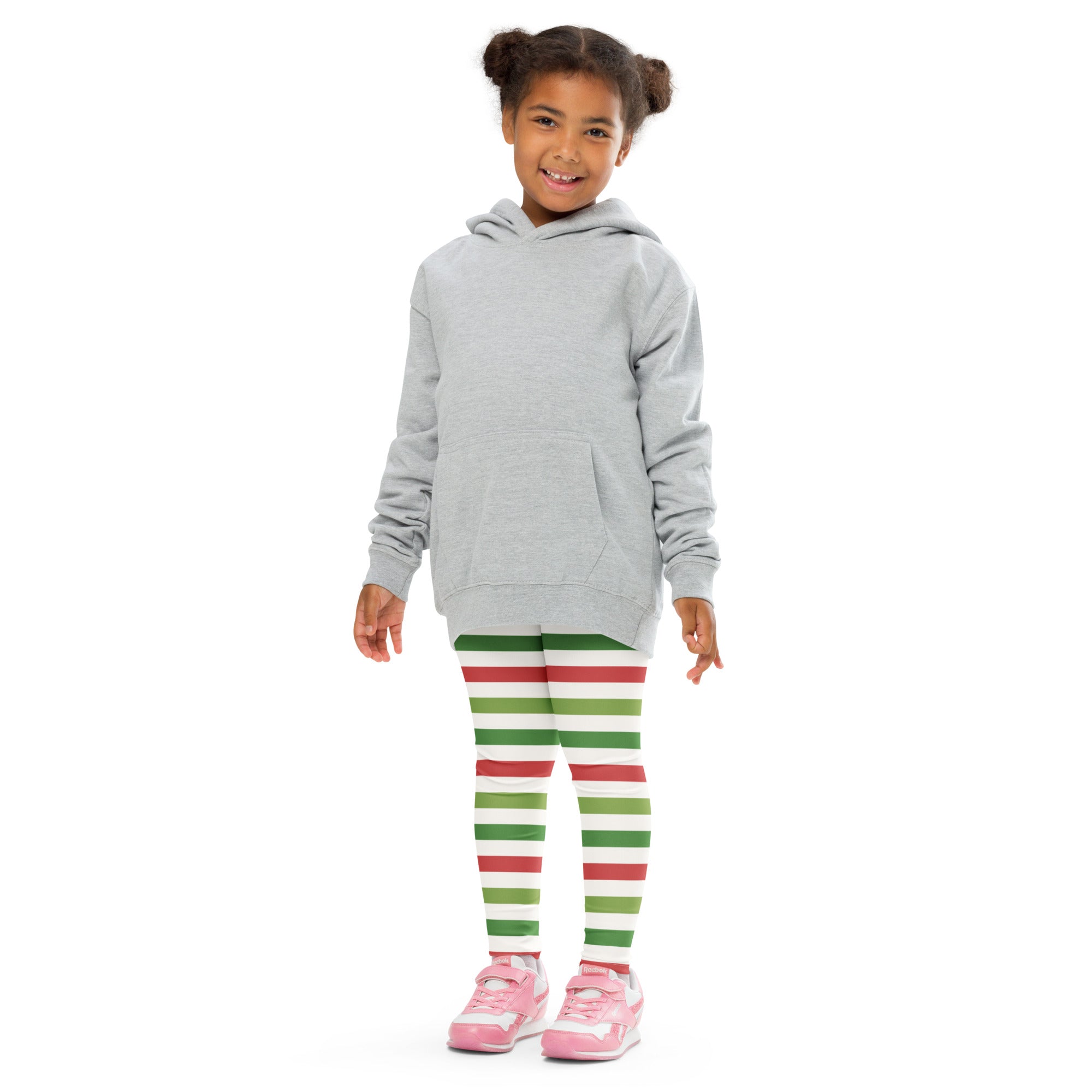 A child wearing kids red and green striped Christmas buttery soft leggings with a light gray hooded sweatshirt