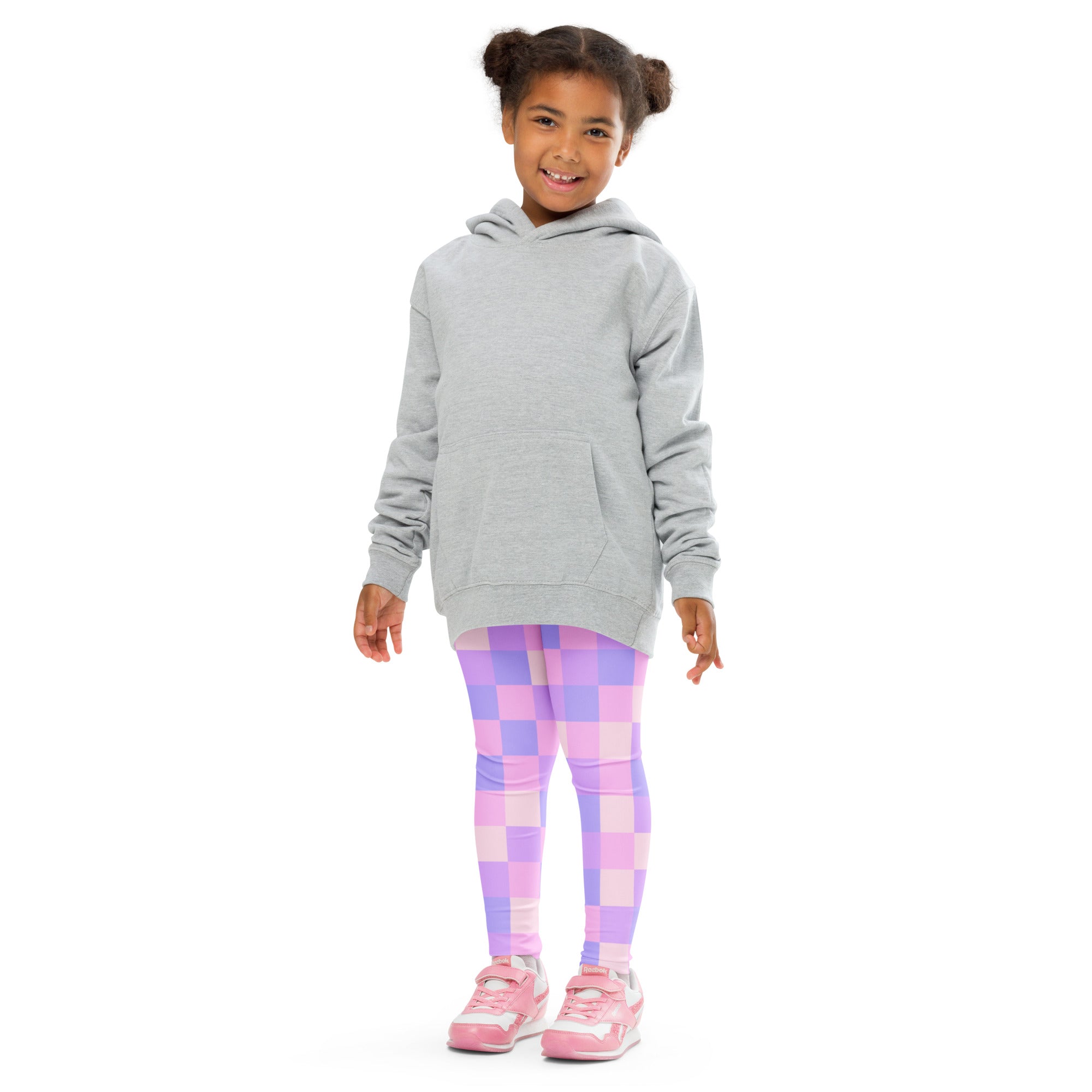 A child wearing girls purple checkered buttery soft leggings paired with a light gray hooded sweatshirt