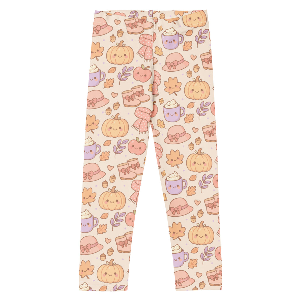 Cream-colored kids cute fall themed buttery soft leggings with playful pumpkins cozy hats and steaming mugs pattern