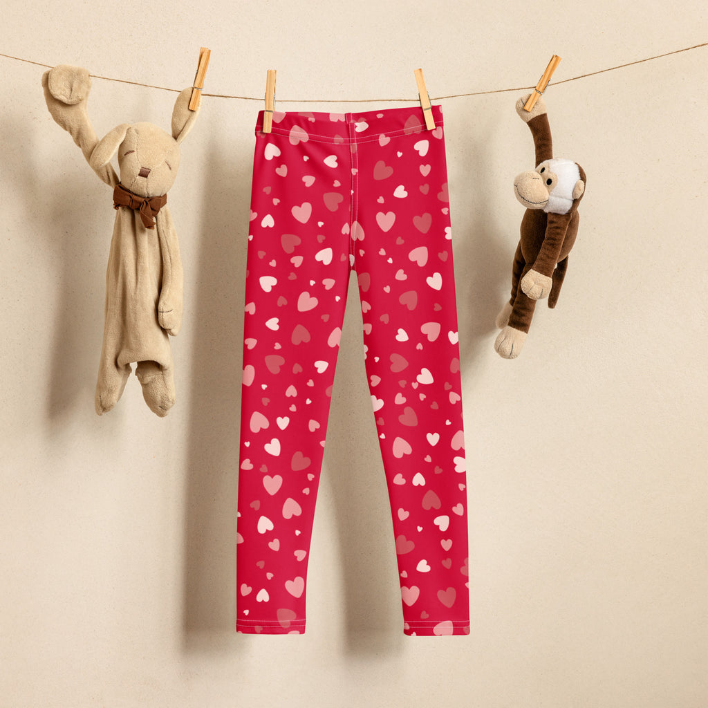 Girls red heart print buttery soft leggings featuring pink and white hearts on stretchy red fabric