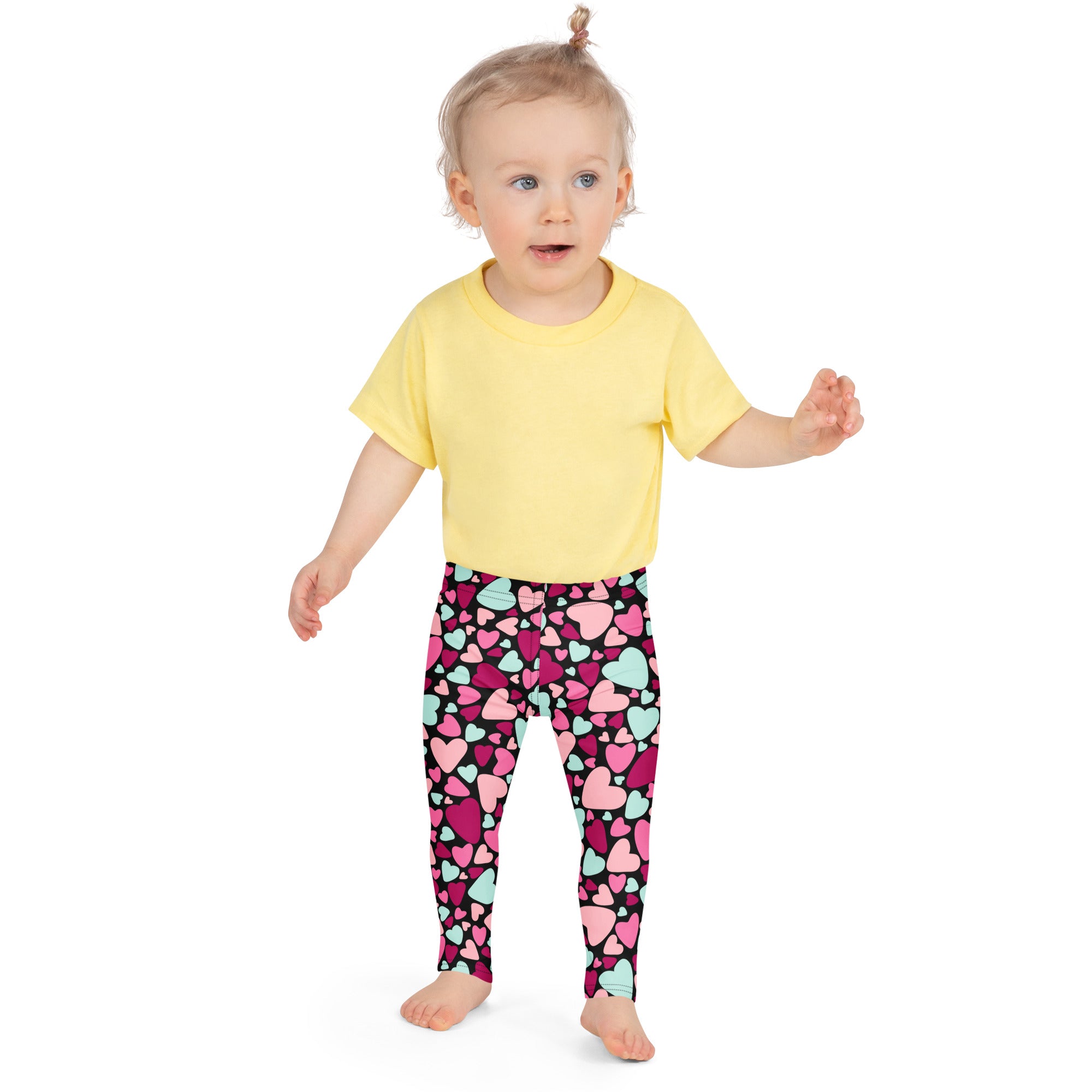 Girls multicolor heart buttery soft leggings with pink and mint heart patterns on a black base