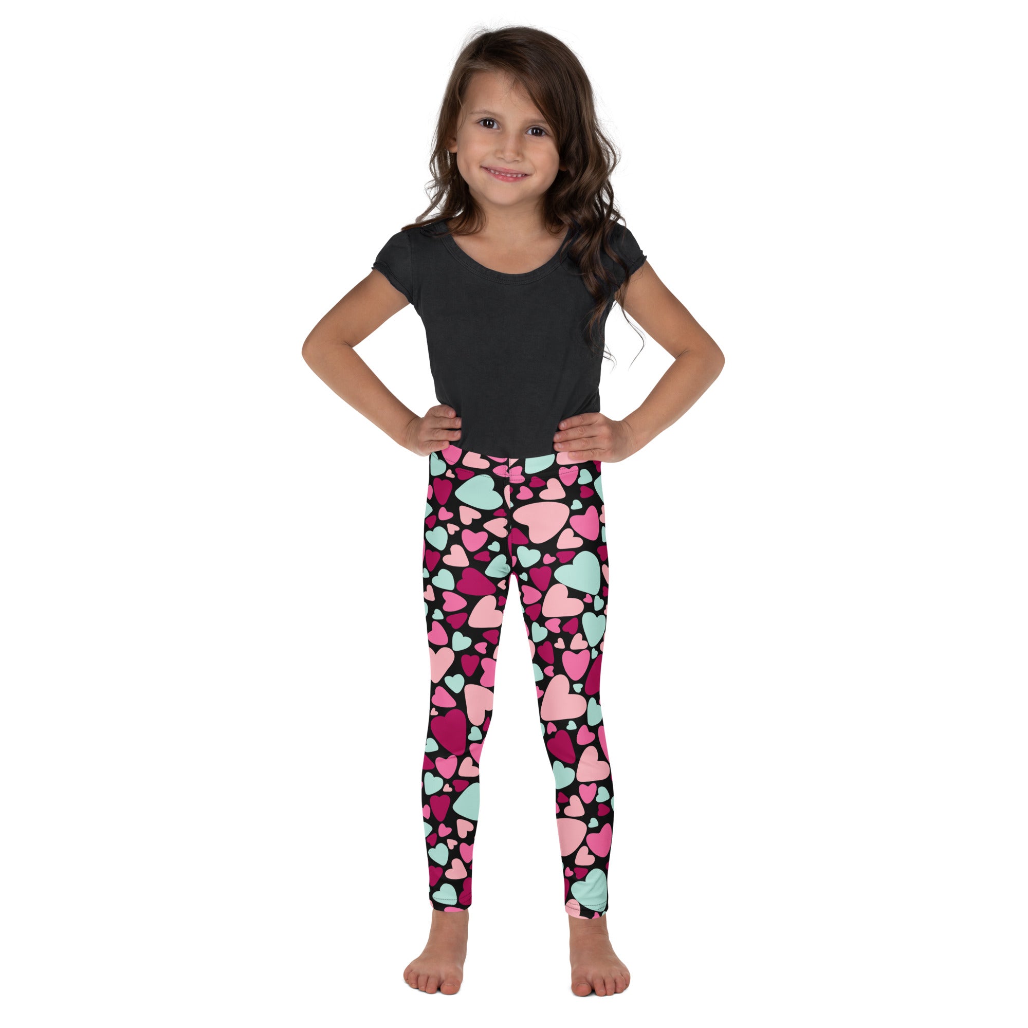Girls multicolor heart buttery soft leggings in pink and mint green worn by a young girl