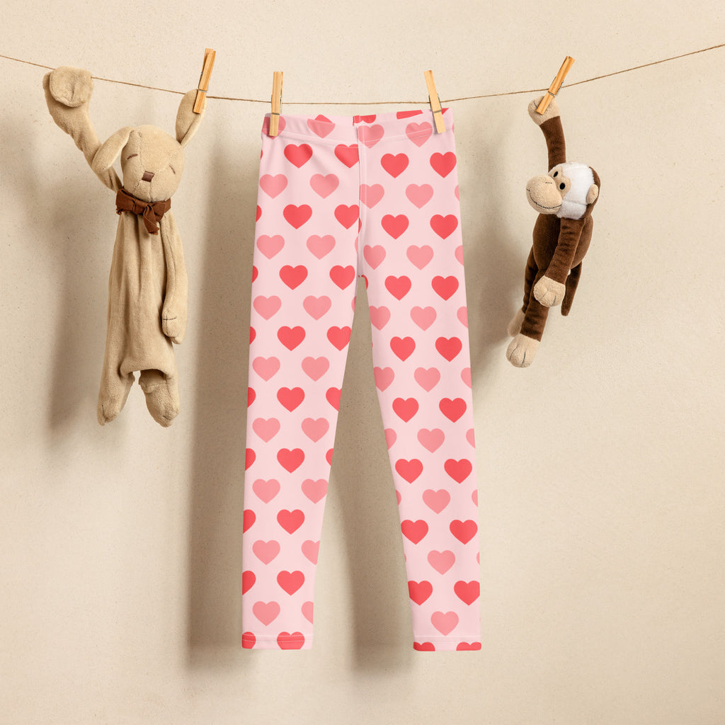 Girls blush heart buttery soft leggings pink heart-patterned hanging on a clothesline showcasing front view