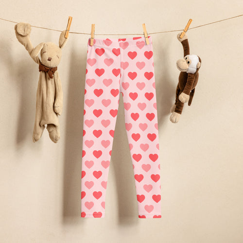 Girls blush heart buttery soft leggings pink heart-patterned hanging on a clothesline showcasing front view