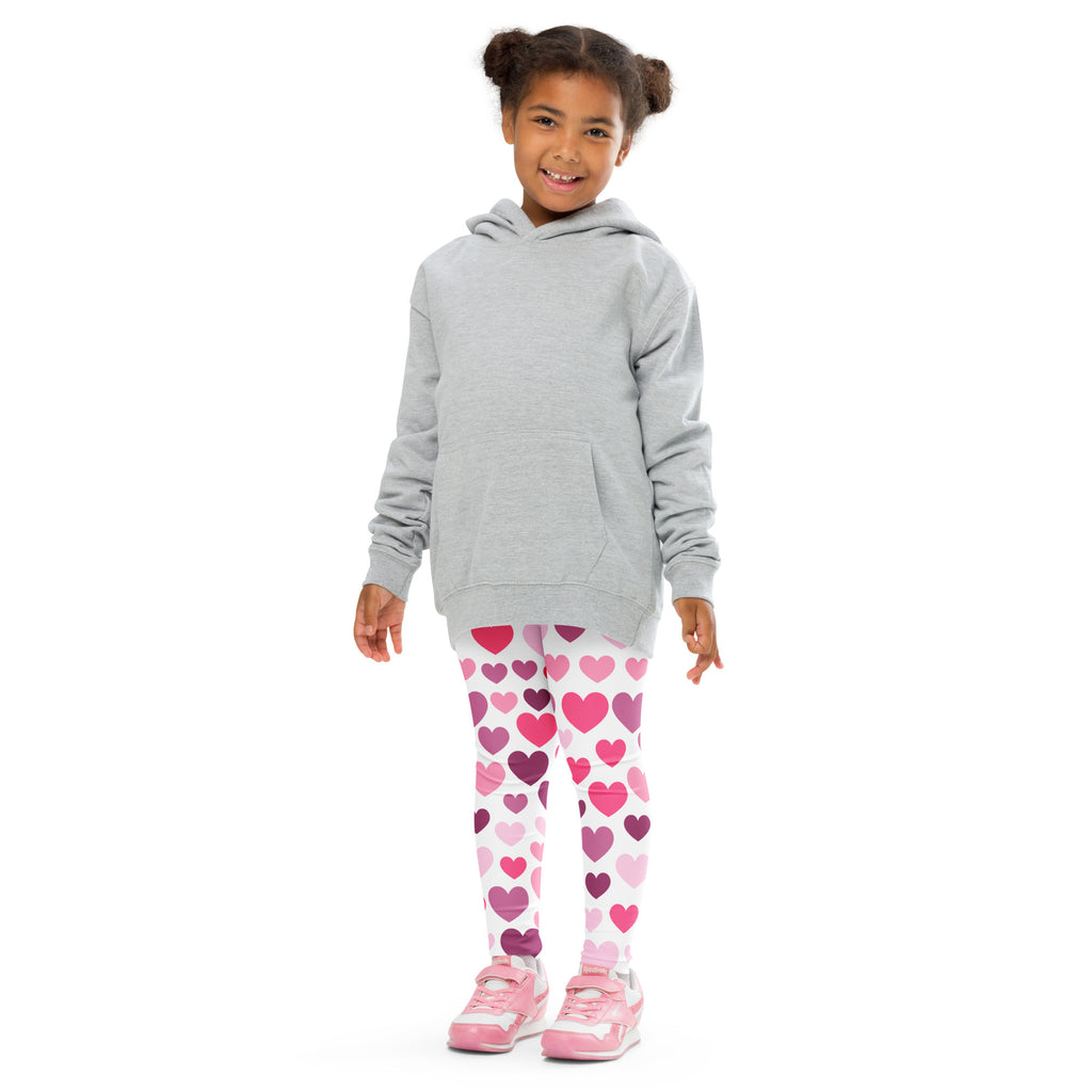 Girl wearing gray hooded sweatshirt with front pocket over girls purple and pink hearts buttery soft leggings